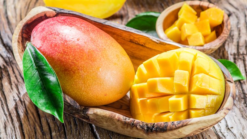 What is the calorie content of mango and what are its benefits and harms