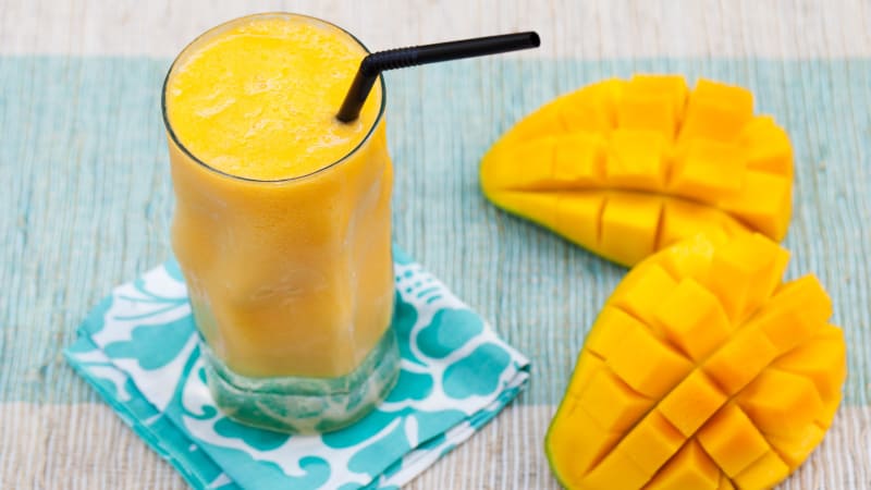 What is the calorie content of mango and what are its benefits and harms